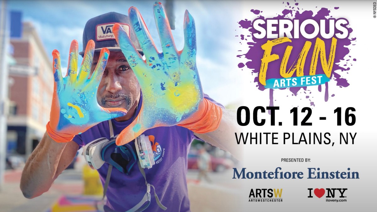 A man holds his hands up to the camera; they're covered in brightly colored paint. To the right, the Serious FUN logo and sponsors.
