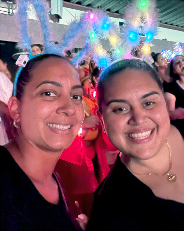 Two women at concert wearing bunny ears