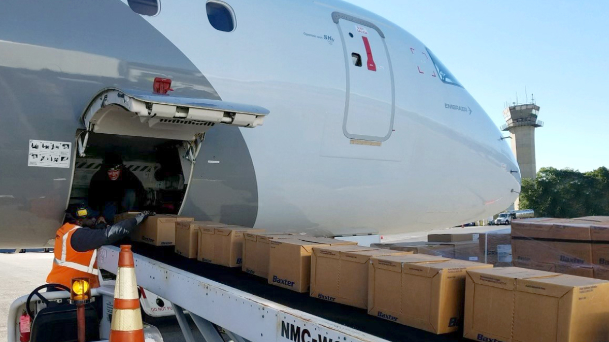 A jet being loaded with supplies via conveyor belt. 