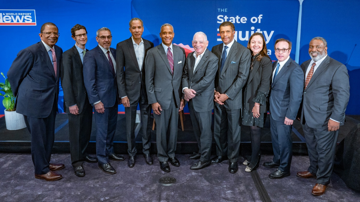 A row of people in formal business attire stand for a photo. (The U.S. News & World Report Panel on Healthcare Equity)