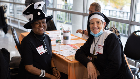 A witch and a nun smile for the camera.