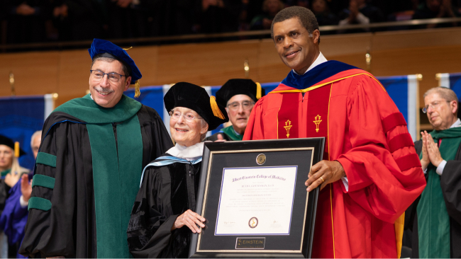 Dr. Gordon F. Tomaselli (left) and Dr. Philip O. Ozuah (right) present Dr. Ruth L. Gottesman (center) with a Doctorate of Humane Letters degree.