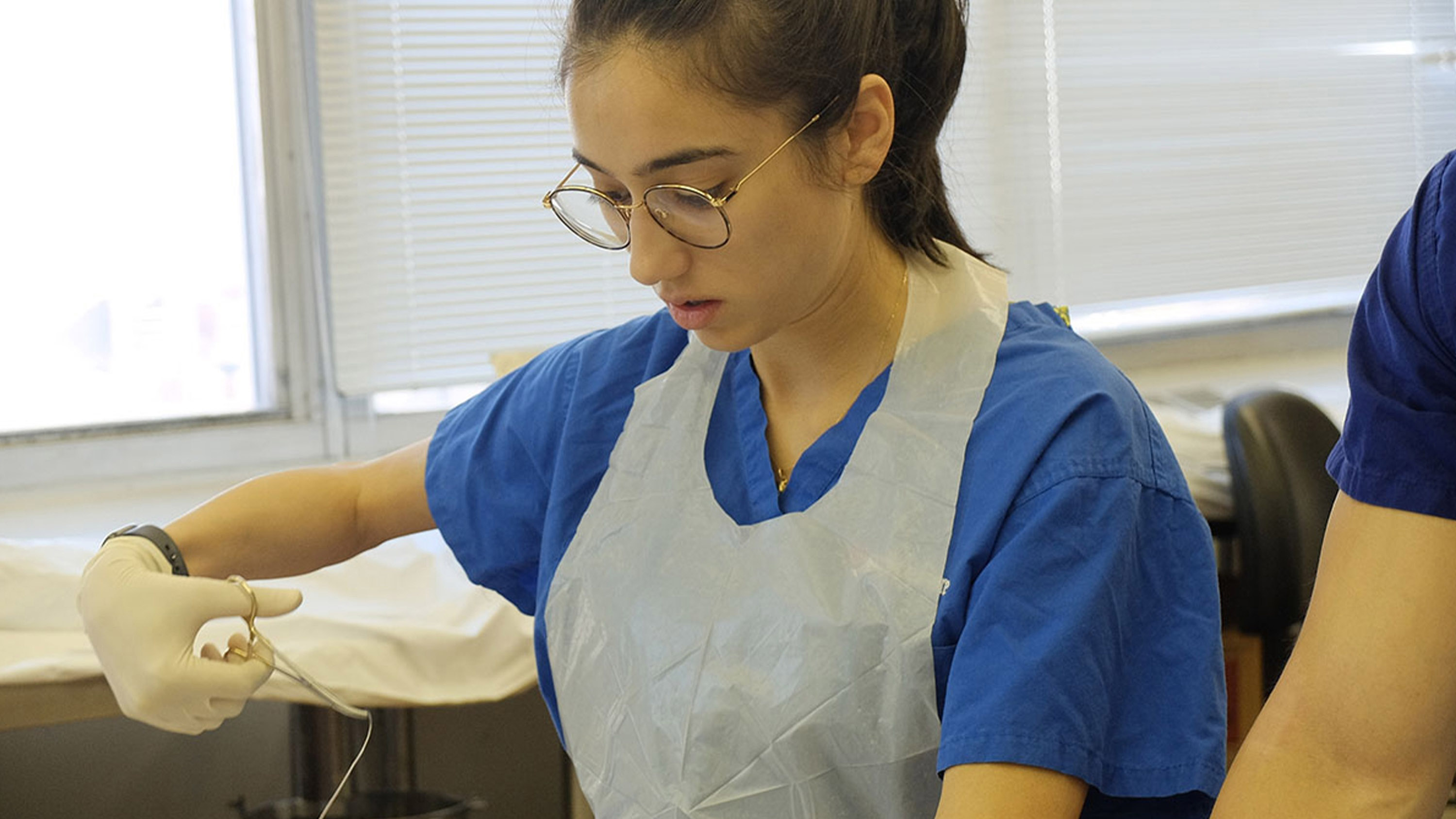 A student practices suture technique.