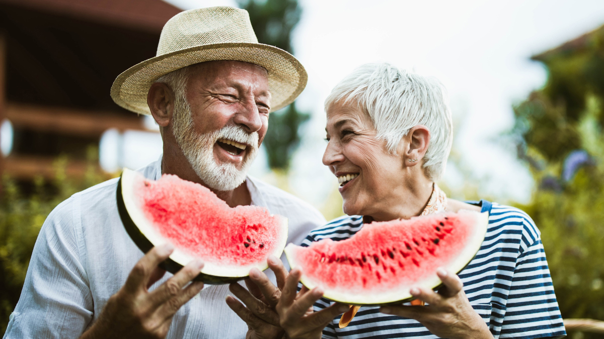 A couple enjoys fresh watermelon.