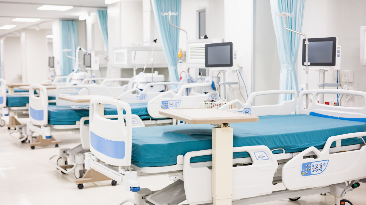 A row of prepared ICU beds in a clean, well-lit hospital ward.
