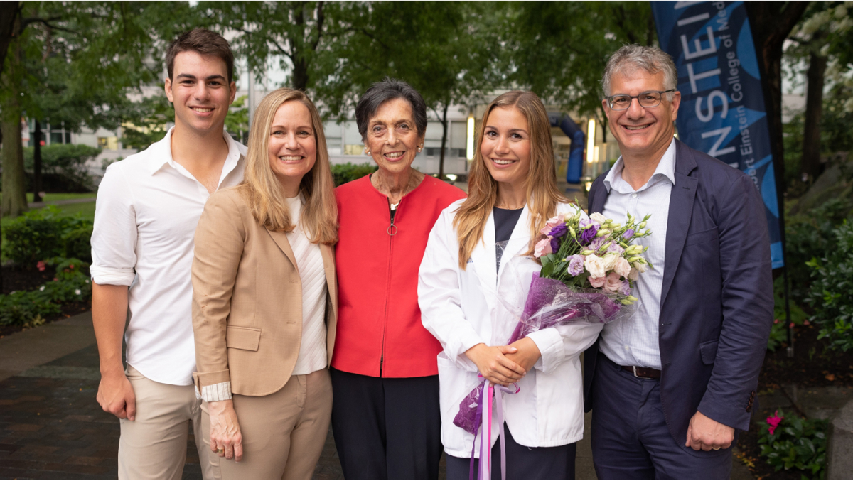 A proud white coat recipient and their family pose for a group photo.