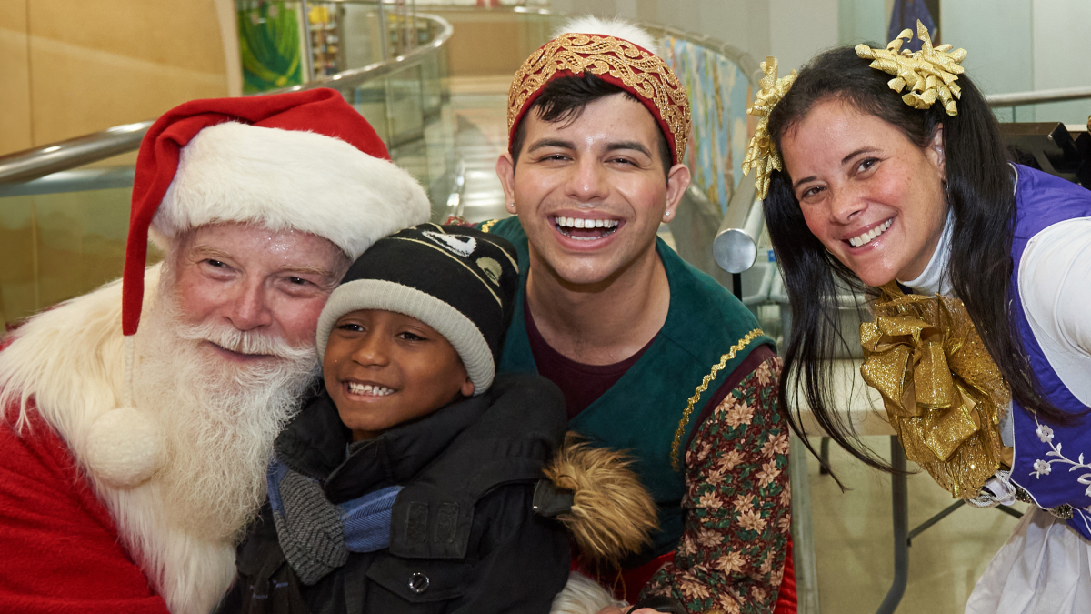 Santa and his helpers bring a smile to a child.