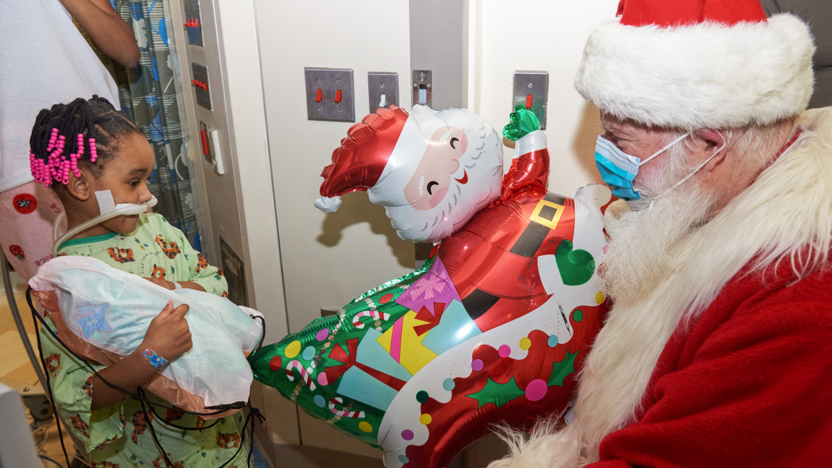 Santa brings a smile to a patient at CHAM.