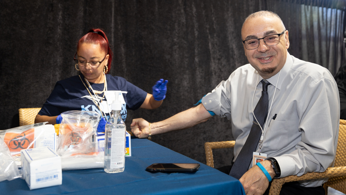 A Montefiore staff member takes a sample from a Yankees staff member for the "Knock Prostate Cancer out of the Park" event.