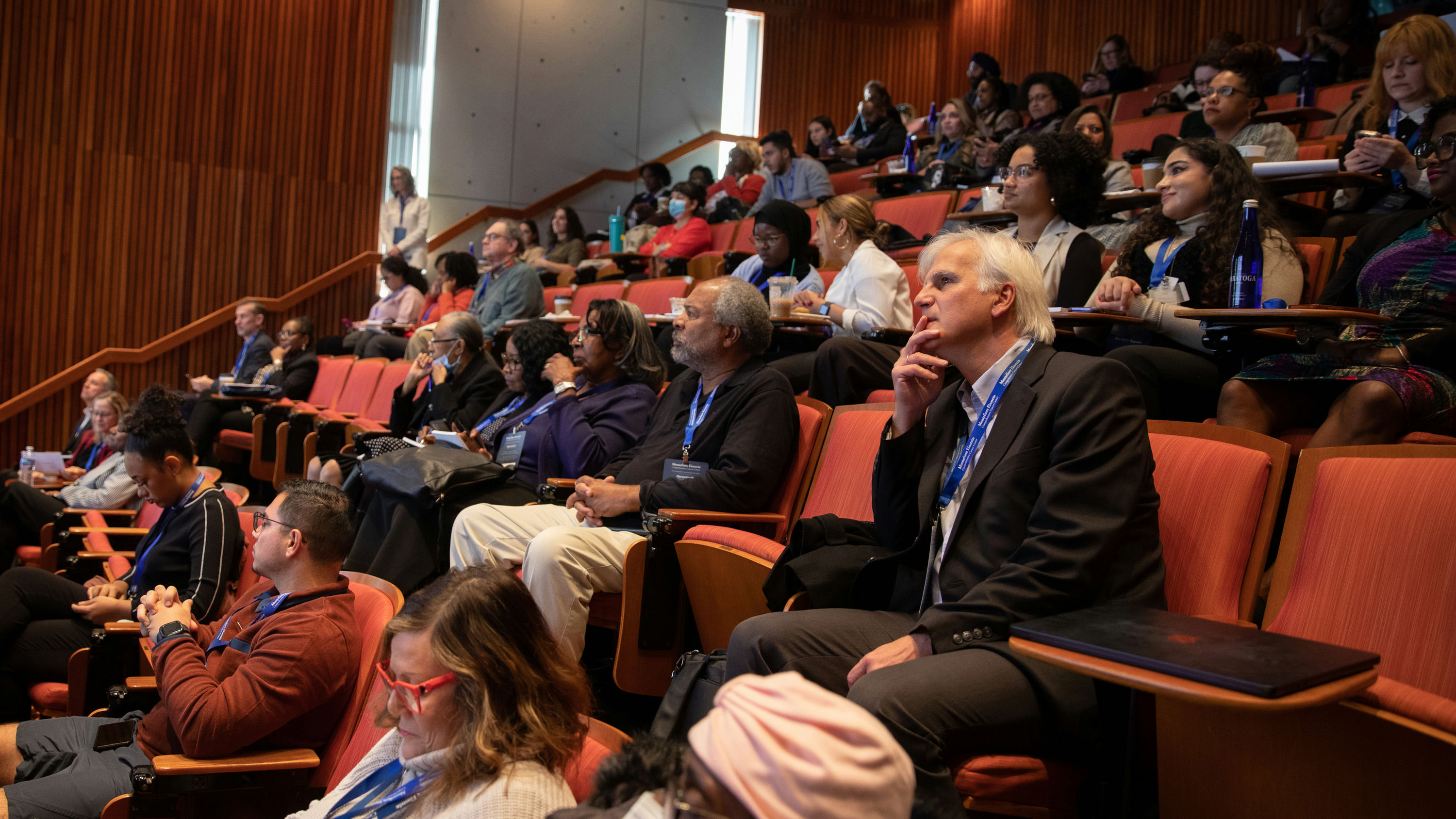 A view of the audience listening to a presenter at the cancer symposium.