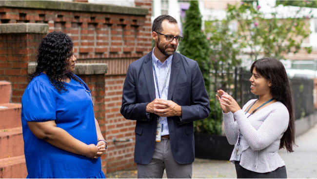 Dr. Fiore talks with two people. 