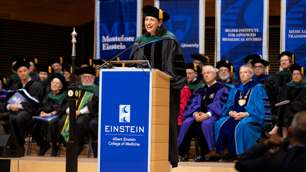 A speaker at a podium addresses the attendees.