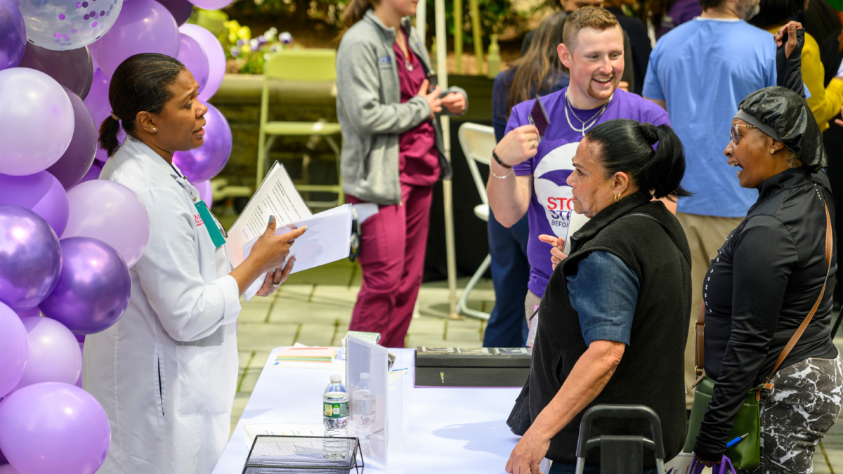 Attendees talk with staffers at the Montefiore Einstein Stroke Awareness event.