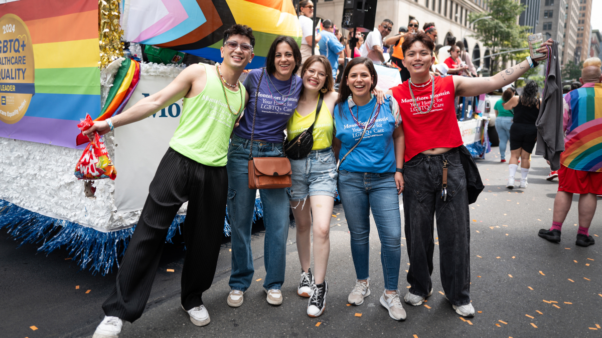 Happy parade goers smile for a group photo.