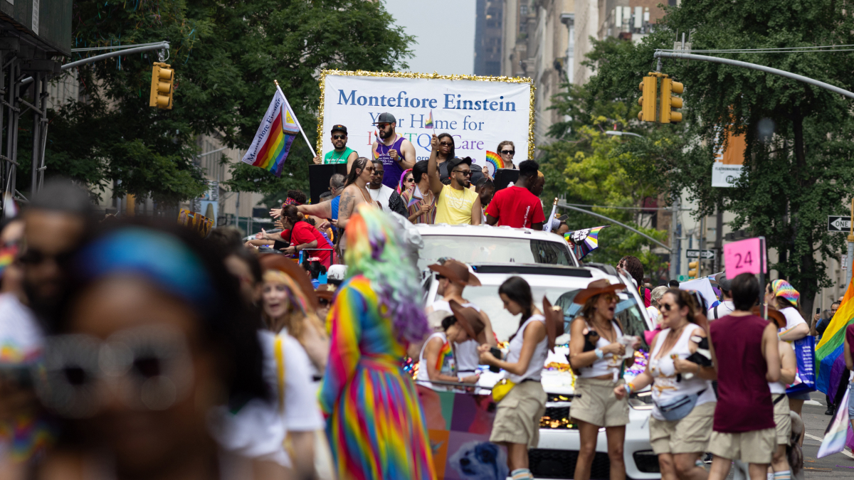 The Montefiore Einstein float moves down the route, along with crowds of parade goers.