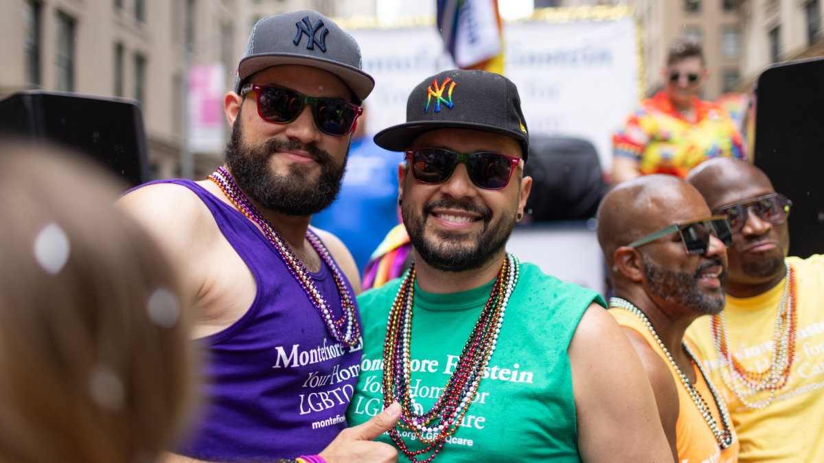 A pair of happy parade goers smile for a picture.