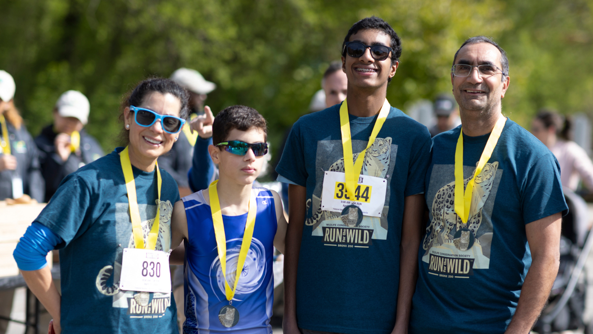 Smiling runners pose with their medals for completing the run.