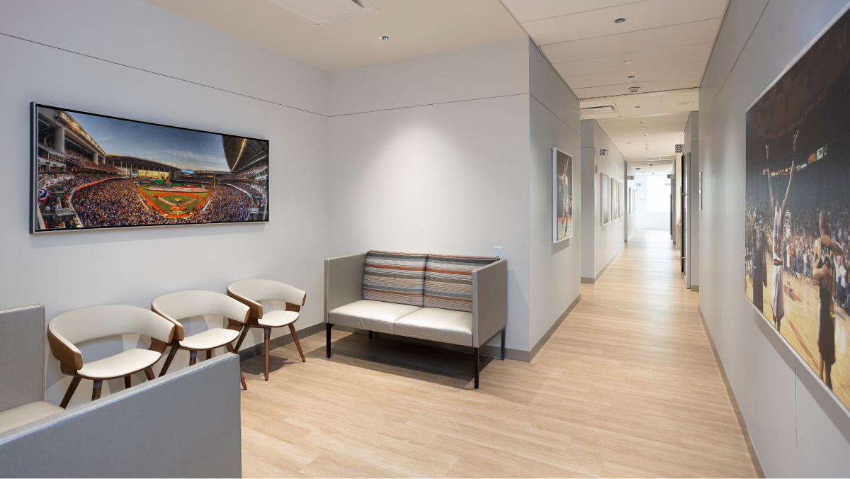 Wood flooring and natural tones, accented with wall art, create a pleasant waiting area.