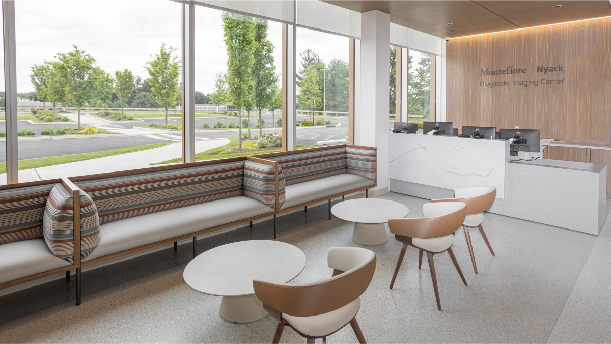 A comfortable waiting area with tables and chairs, in natural tones and materials.