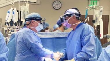 Doctors in operating room shaking hands