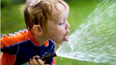 What to Know About Dehydration and How to Avoid It @2x - Picture of boy with Hose