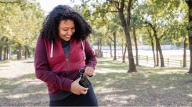 Woman checking device on hip