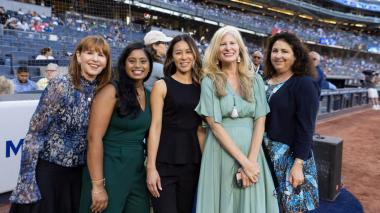 Four doctors standing in baseball field