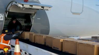 A jet being loaded with supplies via conveyor belt. 