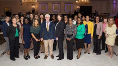 Nursing symposium participants standing in a group for a photo.