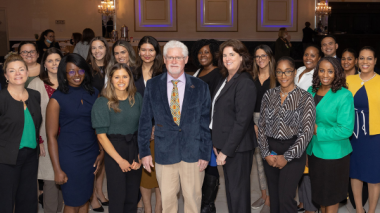 Nursing symposium participants standing in a group for a photo.