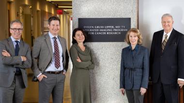 Five people in business attire stand in front of a plaque commemorating Dr. Lipper's donation to the imaging program at Montefiore Einstein.