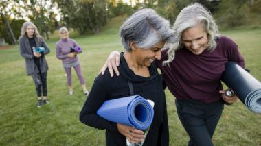 Two women with yoga mats