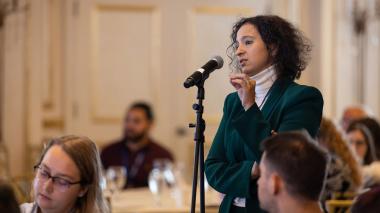 A woman addresses the audience at the Women's Initiative Network.