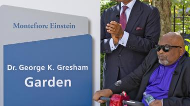 Dr. Gresham and Dr. Ozuah stand next to the new sign for the Dr. George K. Gresham Garden.