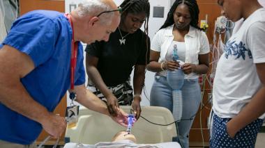 Students learn about procedures from a medical professional.