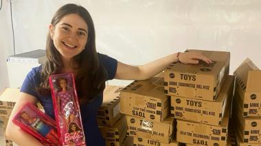 Photo of young woman with barbie dolls