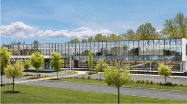 A view of a glass-fronted professional medical building; Montefiore Einstein Orthopedic Surgery, Montefiore Einstein Advanced Care, Montefiore Nyack and Burke Rehabilitation all offer services under one roof in the custom-designed, future-forward facility.