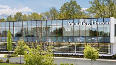 A view of a glass-fronted professional medical building; Montefiore Einstein Orthopedic Surgery, Montefiore Einstein Advanced Care, Montefiore Nyack and Burke Rehabilitation all offer services under one roof in the custom-designed, future-forward facility.