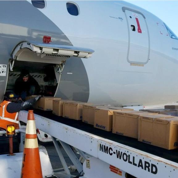 A jet being loaded with supplies via conveyor belt. 